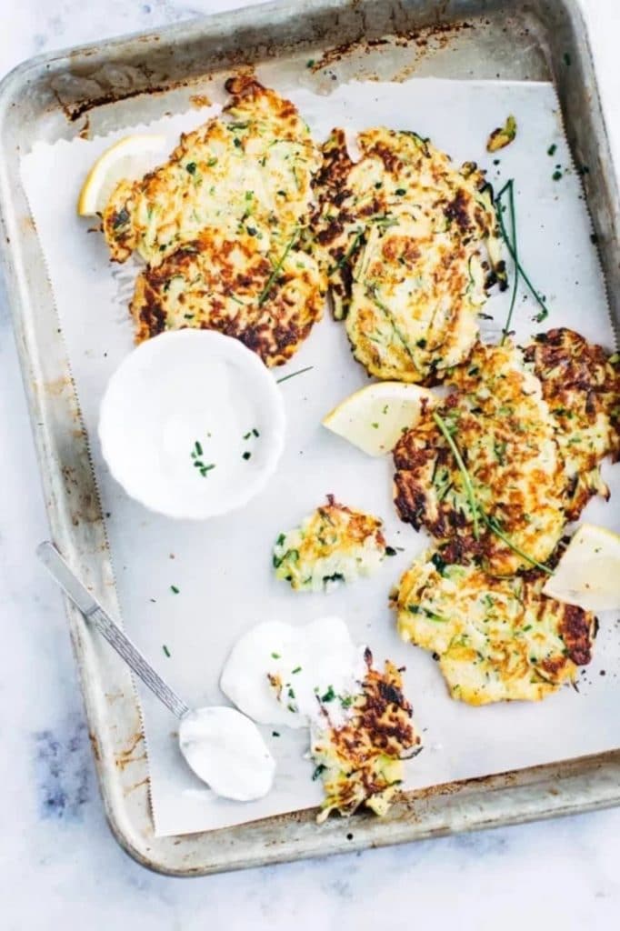 These oven baked, crispy Zucchini Fritters recipe are so quick to make and make a great savoury breakfast or a delicious party appetizer! Made with bread crumbs, they're the perfect zucchini recipe for leftover summer squash and so easy to make!