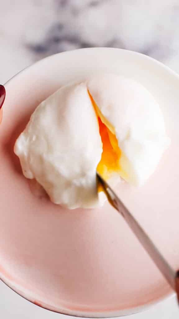 Cutting a runny poached egg in the microwave
