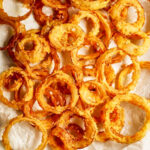 Flaky onion rings on a tray.