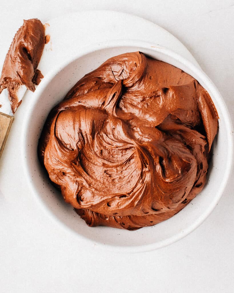 A bowl of whipped chocolate frosting.