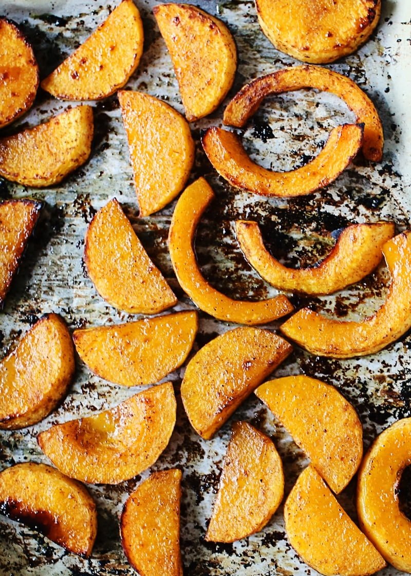 slices of roasted butternut squash on a baking sheet.