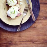 Steak eggs benedict topped with blue cheese hollandaise and chives.
