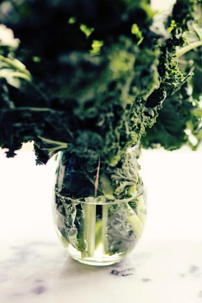 Fresh kale in a glass of water
