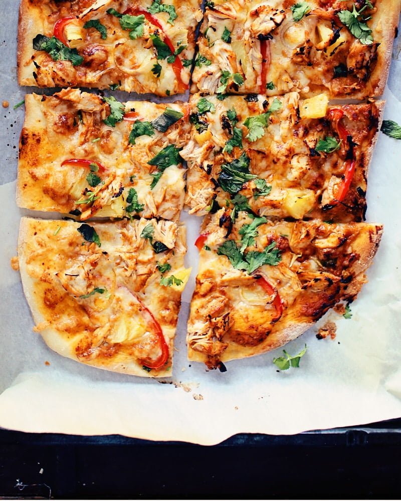 Butter chicken pizza (Indian pizza) on a baking sheet.
