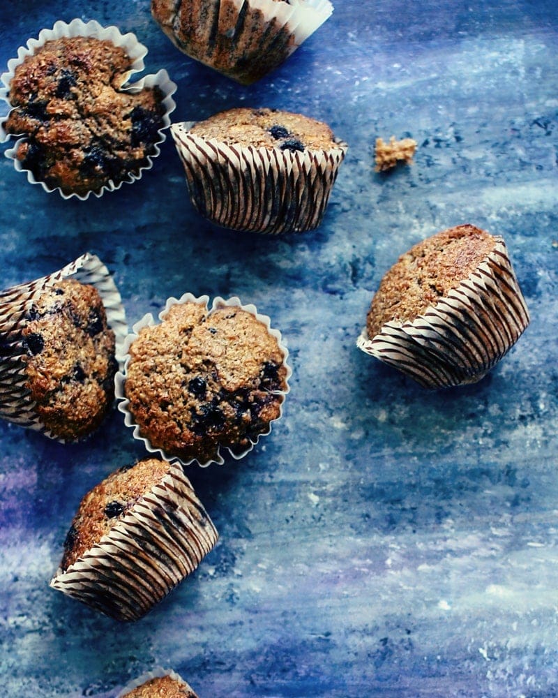 healthy blueberry bran muffins on a blue background