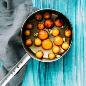 Gulab Jamun in syrup on the stove.