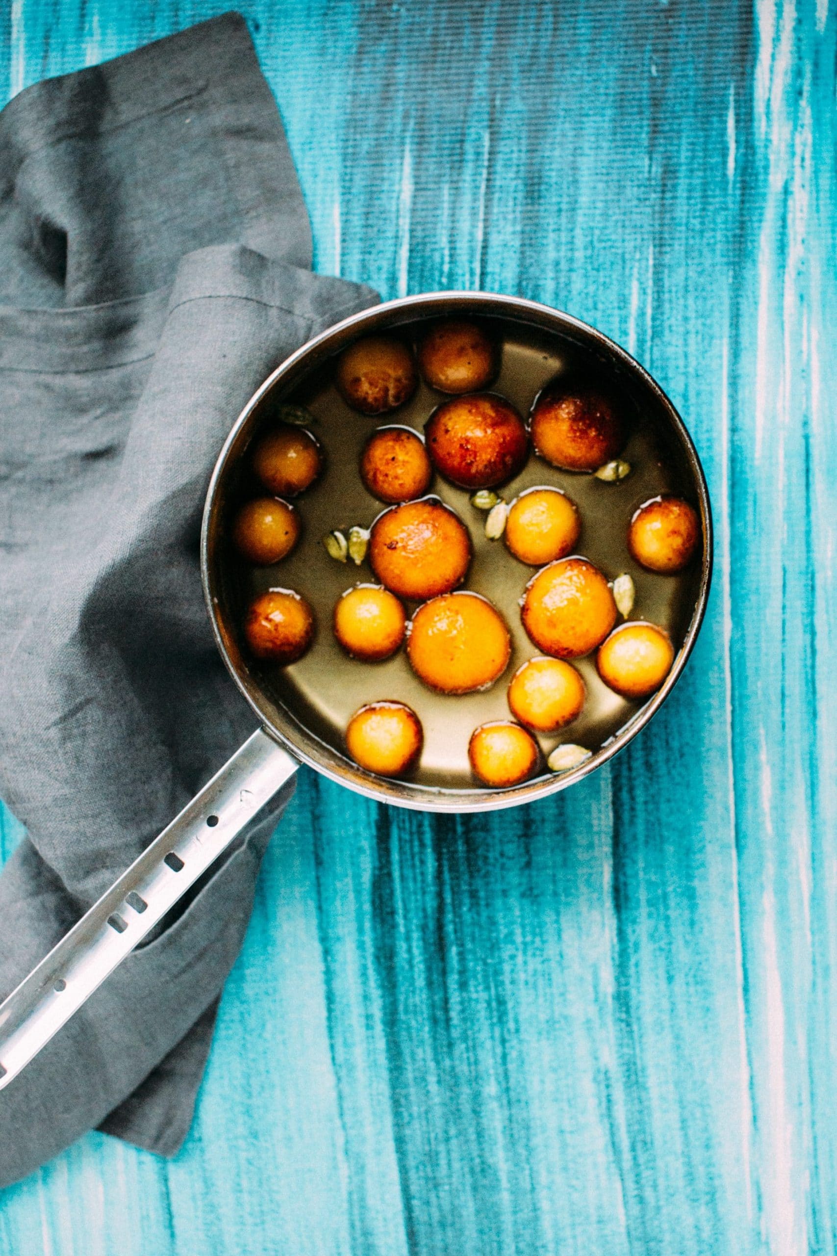 Gulab Jamun in syrup on the stove.