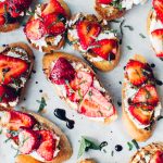 Strawberry Goat Cheese Crostini on parchment paper.