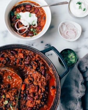 chili with ground beef in a pot and a bowl.