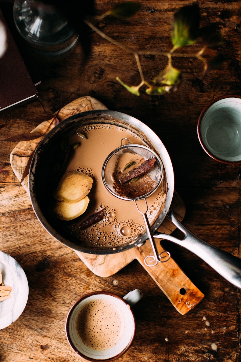 indian chai tea from scratch in a pot with whole cinnamon