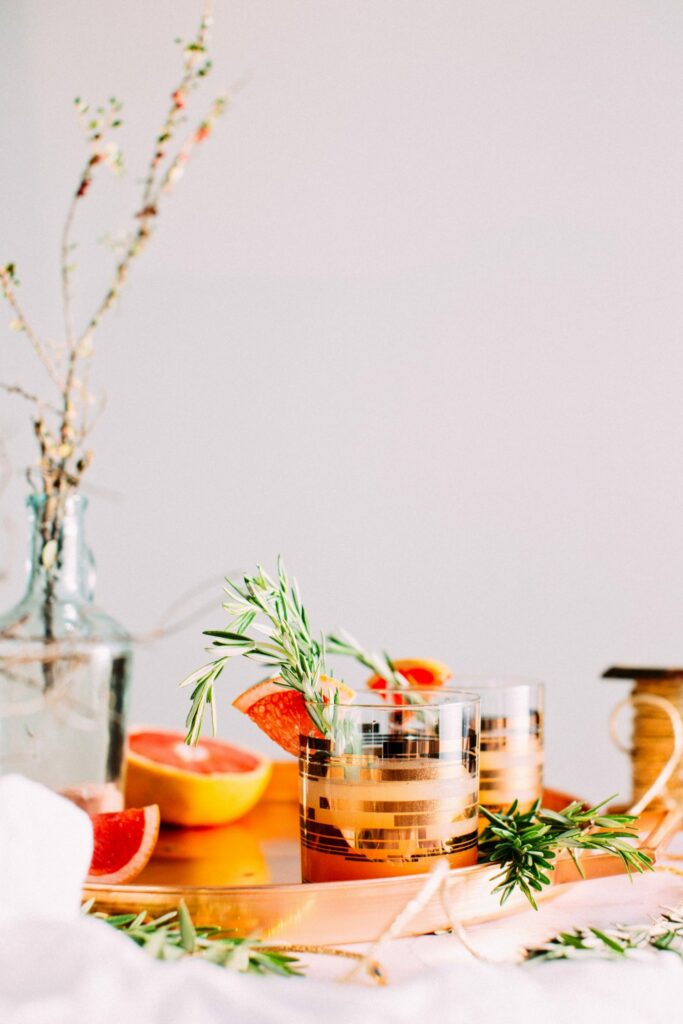 A fizzy grapefruit and rosemary gin cocktail in a glass.