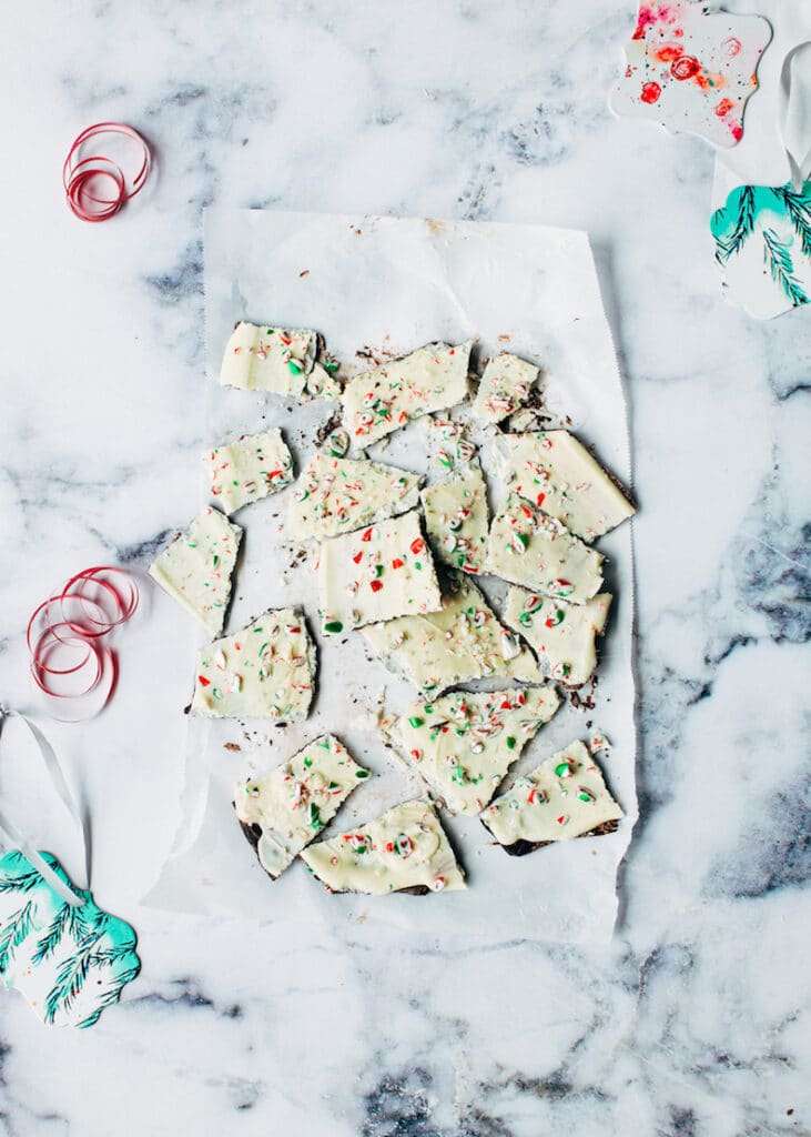 No-bake white chocolate candy cane christmas bark pieces on parchment