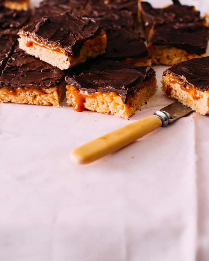 Slices of Salted Caramel Rice Krispie Treats with a knife.