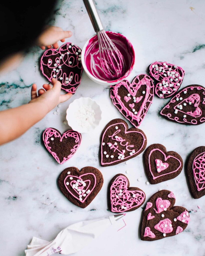 decorated chocolate sugar cookies on a kitchen countertop