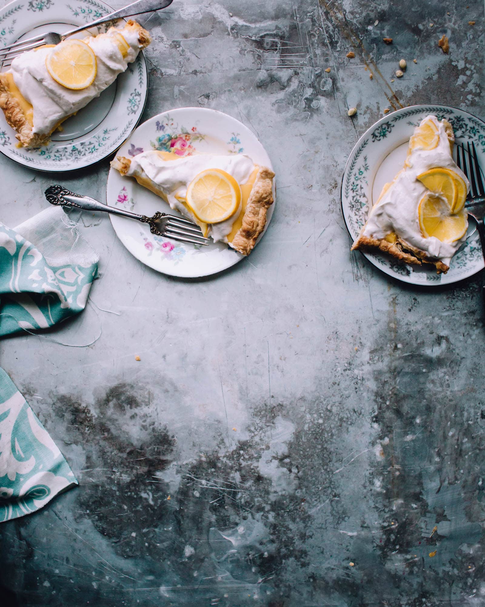 Slices of easy lemon tart on plates with whipped cream.