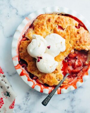 Strawberry Cobbler with ice cream and a spoon.