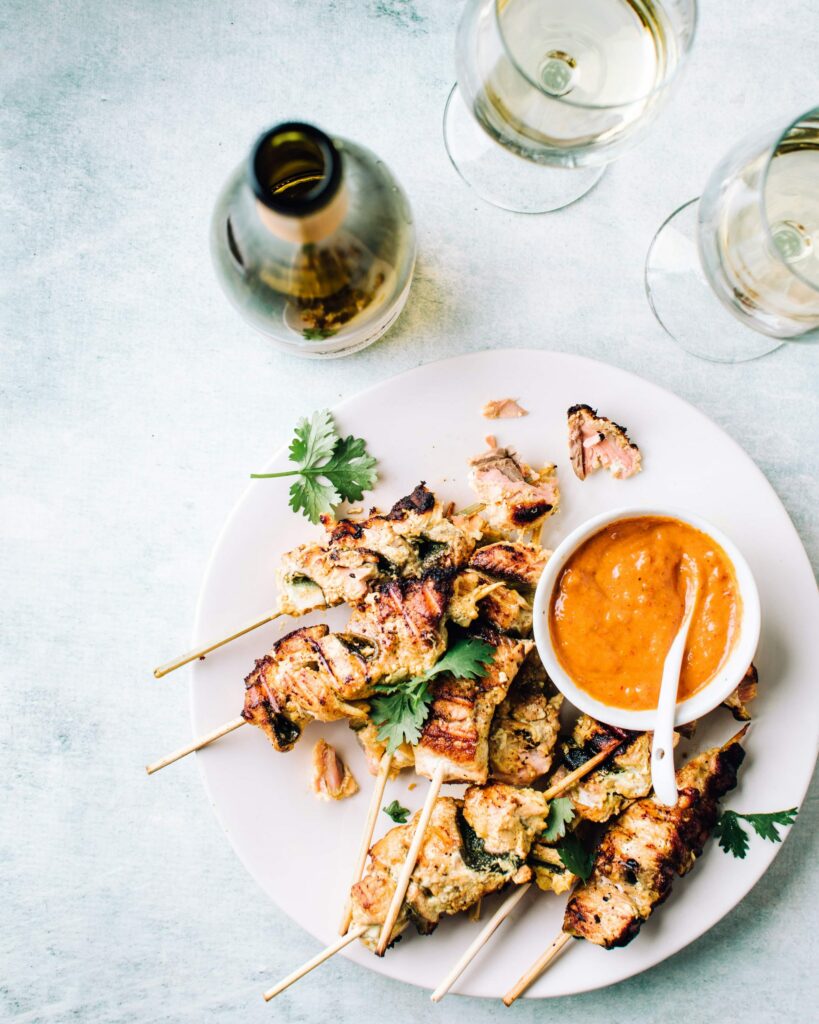 Grilled coconut salmon skewers with peanut sauce.