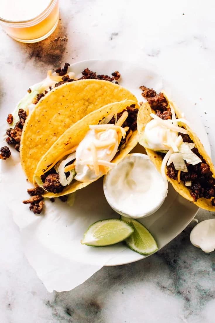 These tested-till-perfect, crazy-delicious ground beef tacos are the best easy taco recipe you will ever try! Throw your powered store-bought Mexican taco seasoning mix - I've got a secret trick to season your taco meat. The perfect taco toppings? Sour cream, lettuce and cheddar cheese, of course.
