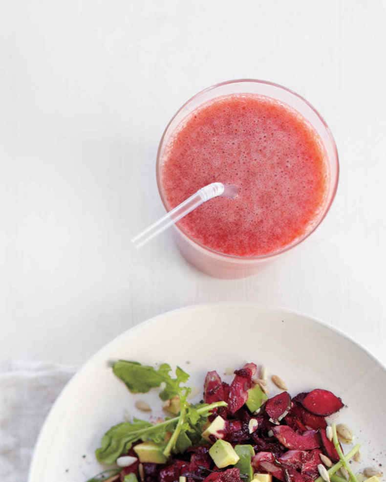 strawberry grapefruit smoothie with a plate of crisp salad