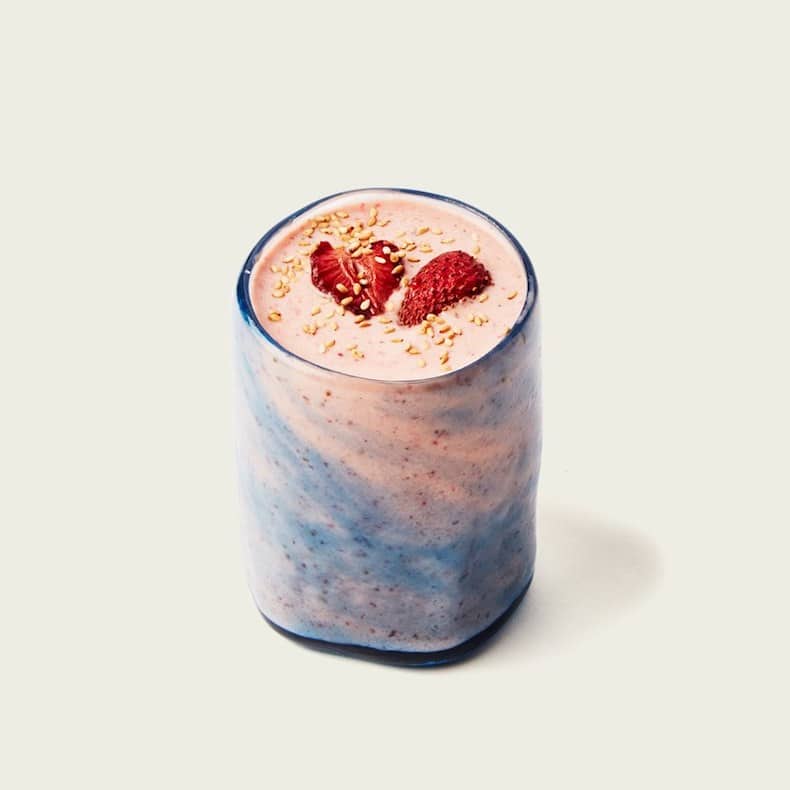 strawberry smoothie in glass with blue swirl