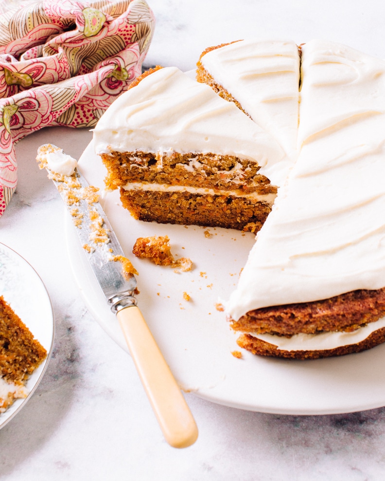 a homemade carrot cake with icing on a knife