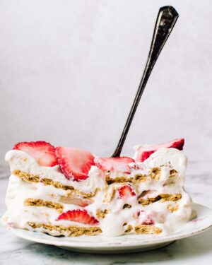 A slice of strawberry cream cheese icebox cake.