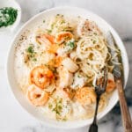 Easy Seafood Pasta recipe with cream sauce on a plate with a fork and knife.