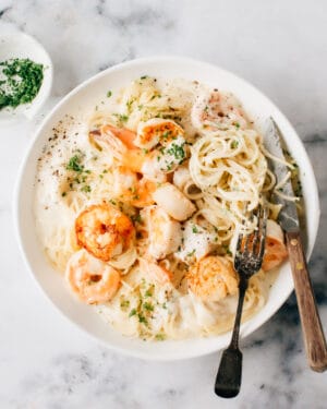 Easy Seafood Pasta Recipe on a plate with a fork and knife.