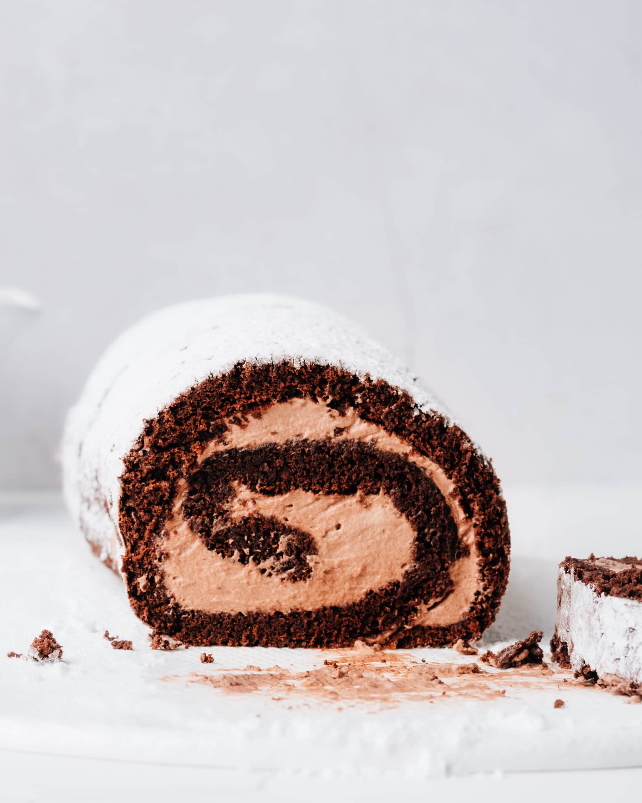 Sliced Chocolate Swiss Roll Cake on the counter.