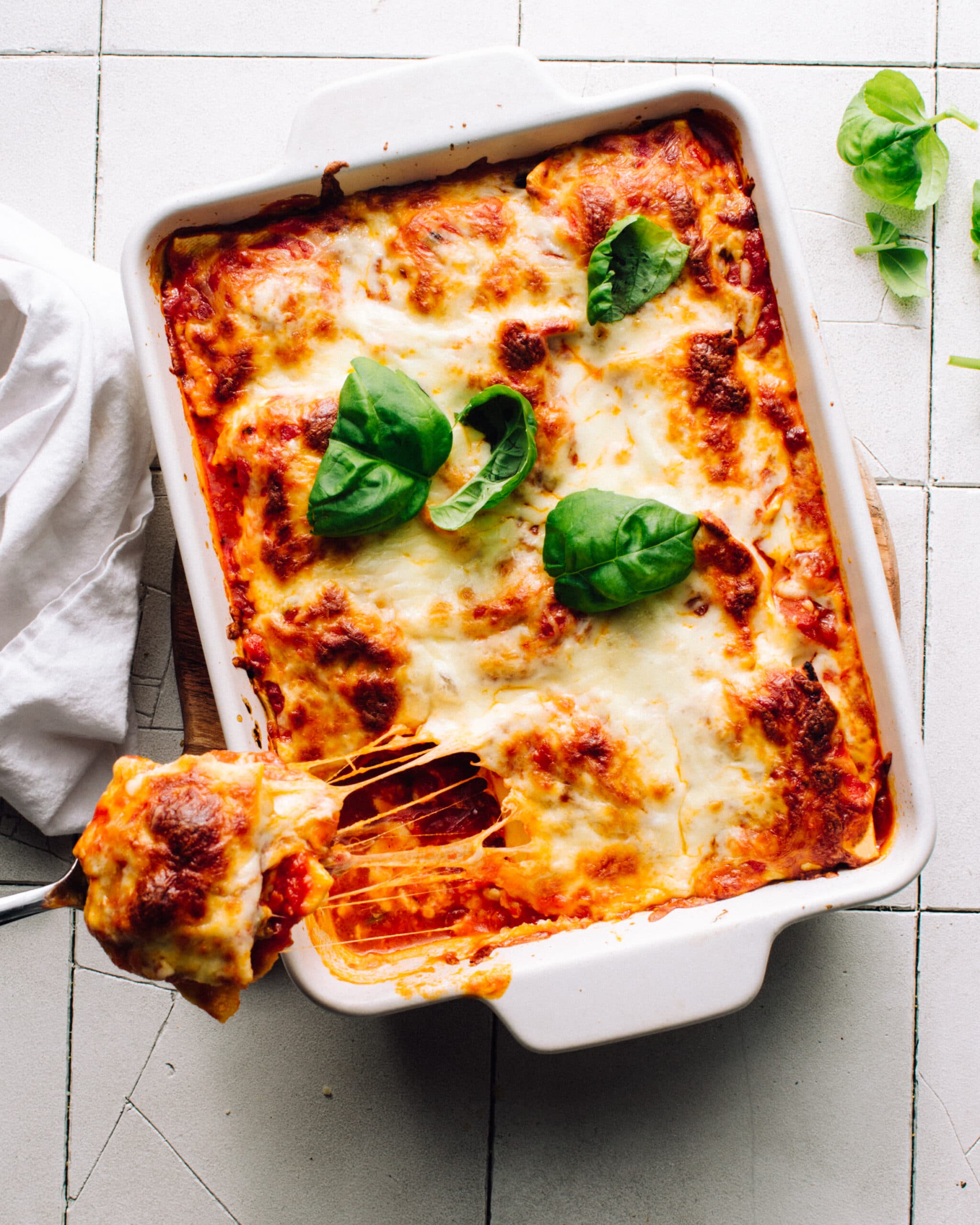 3-Ingredient Lazy Lasagna in a pan with a cheesy scoop being pulled out.
