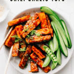 Try this mouth-watering chili garlic tofu recipe with an incredible sweet and spicy sauce for a healthy source of vegan protein. Whip it up in minutes and be blown away.