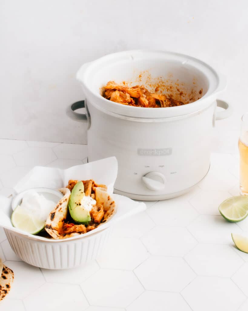 These easy Shredded (or pulled) Chicken Tacos are cooked in a crockpot with the best, crazy-delicious sauce. You don't want to miss my tips for the best way to shred chicken, plus a comprehensive list of yummy chicken taco toppings. A slow cooker makes this healthy recipe super simple and hands off.