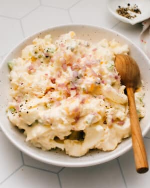 This Classic Homemade Potato Salad recipe is the best I've made. It is super easy with a tangy, lemony, creamy mayonnaise-based dressing that I lighten up with Greek yogurt. The mix-in possibilities are endless with this tested-till-perfect, from-scratch recipe as your canvas