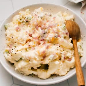 This Classic Homemade Potato Salad with egg recipe is the best I've made. It is super easy with a tangy, lemony, creamy mayonnaise-based dressing that I lighten up with Greek yogurt. The mix-in possibilities are endless with this tested-till-perfect, from-scratch recipe as your canvas
