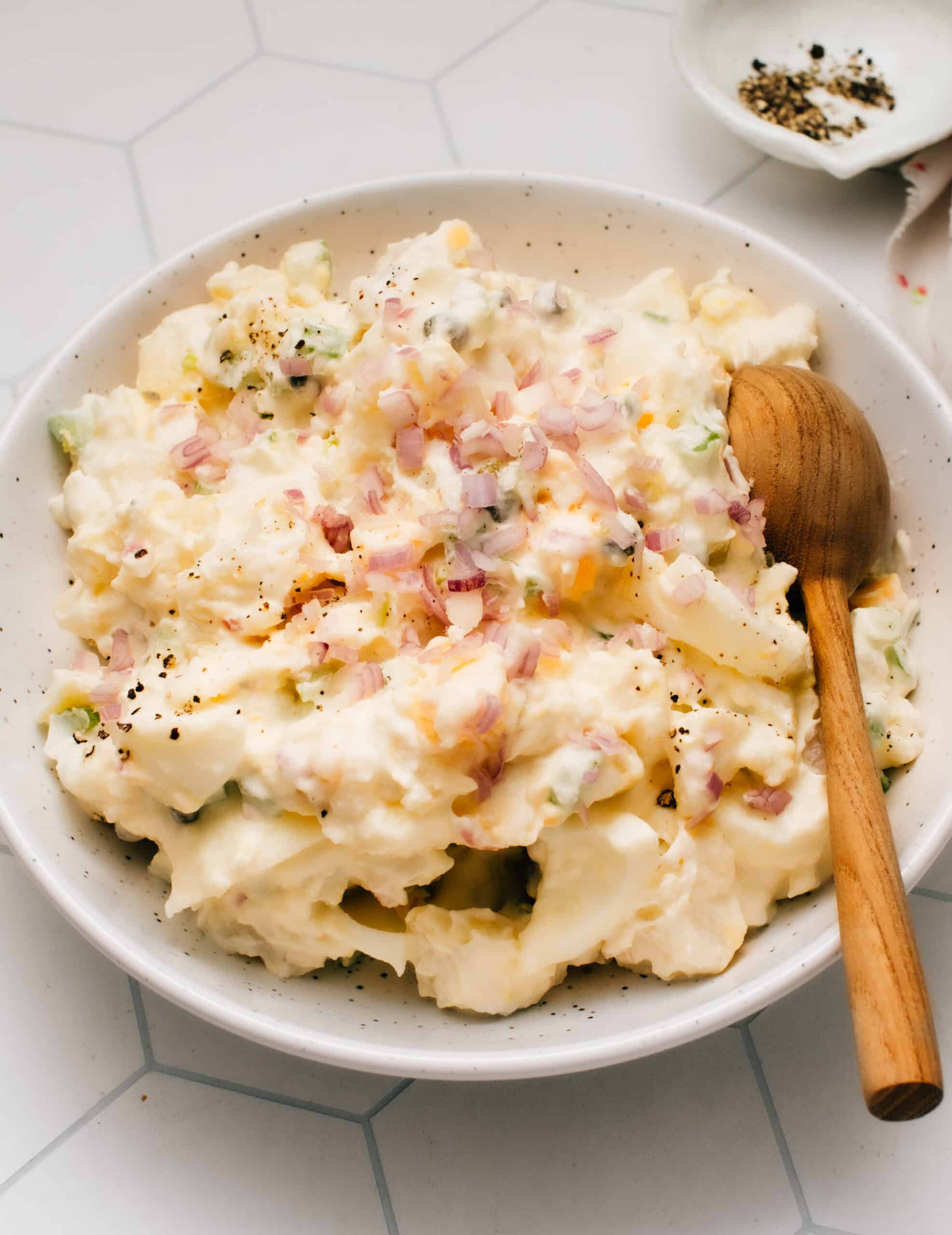 This Classic Homemade Potato Salad with egg recipe is the best I've made. It is super easy with a tangy, lemony, creamy mayonnaise-based dressing that I lighten up with Greek yogurt. The mix-in possibilities are endless with this tested-till-perfect, from-scratch recipe as your canvas