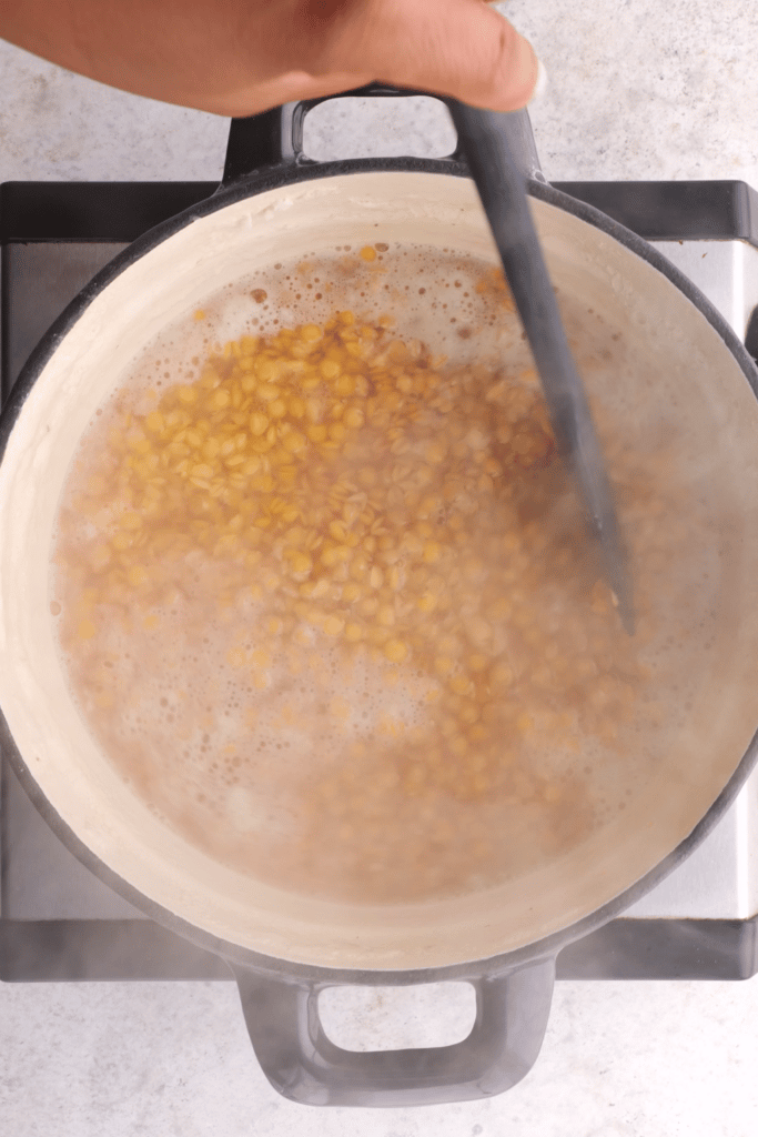 Cooking red lentils in a pot.