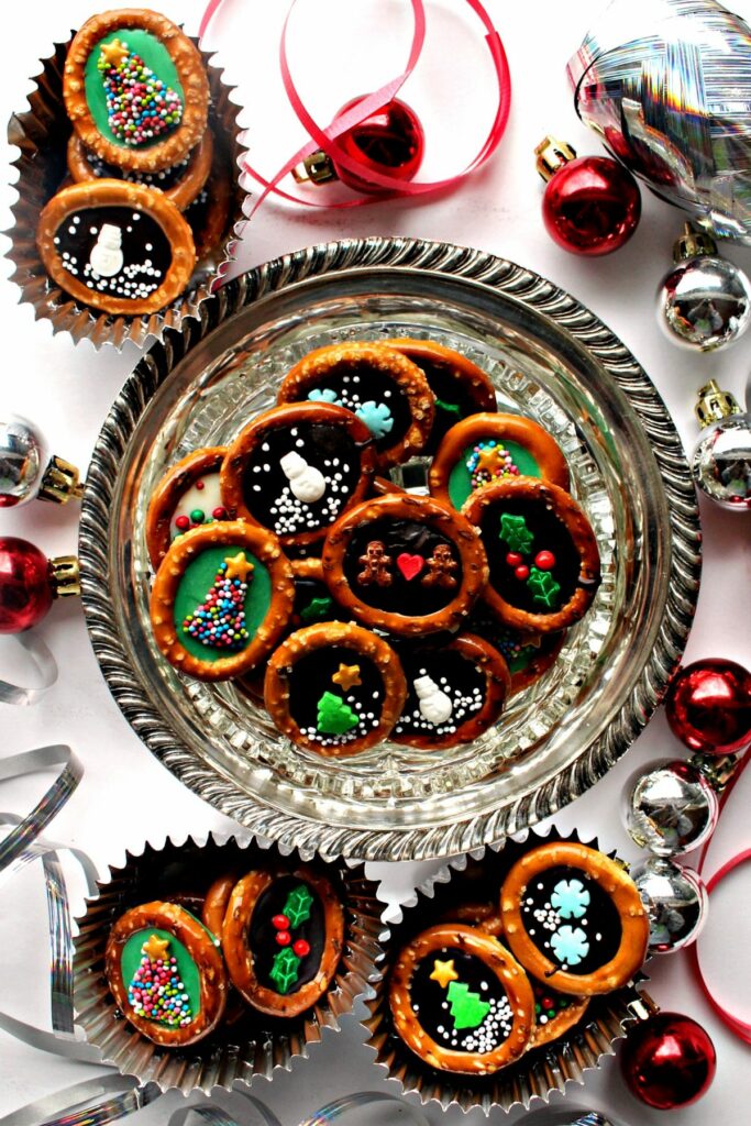 Decorated No-bake Christmas pretzels on a platter.