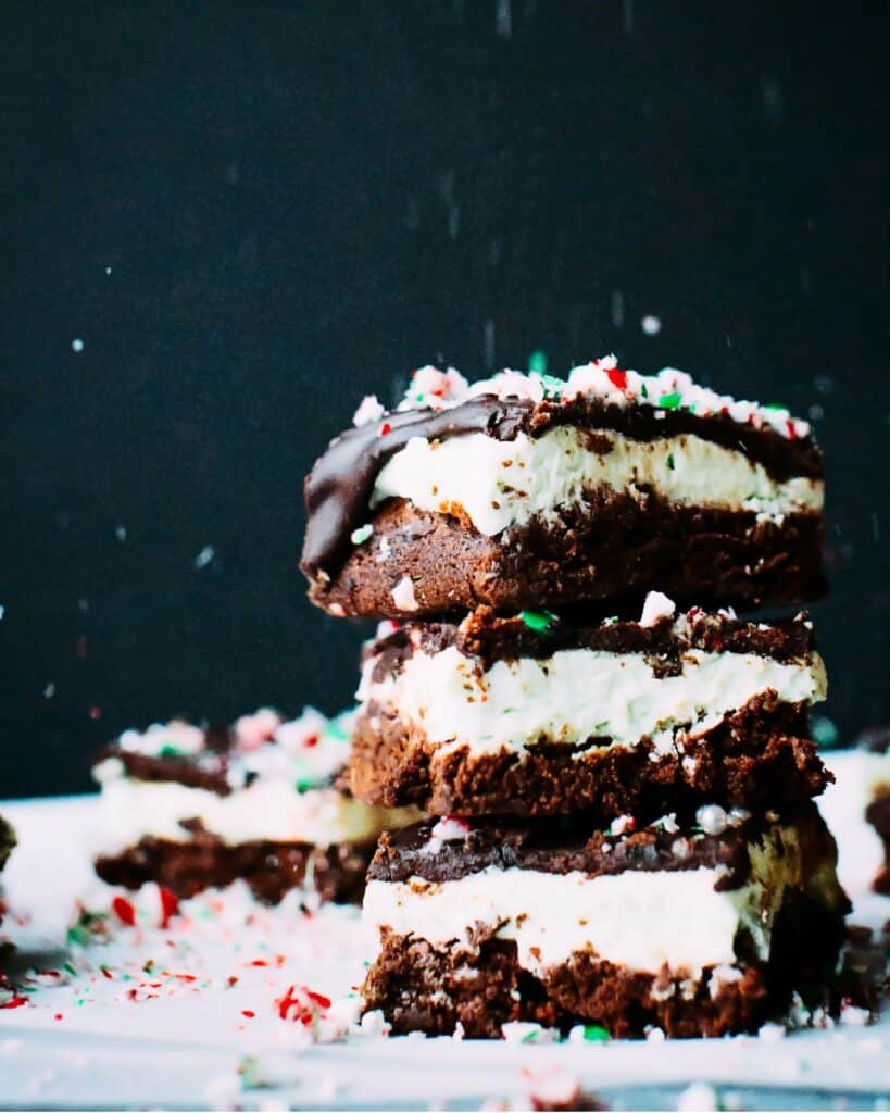 Stack of Chocolate Mint brownies with peppermint buttercream frosting and chocolate ganache