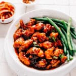 Gochujang chicken and green beans in a shallow bowl ready to enjoy.