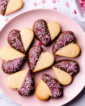 Valentine's sugar cookies on a pink plate.