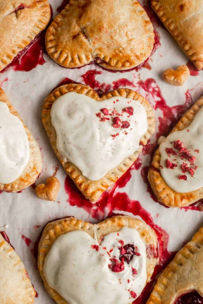 Valentine's Day Raspberry Hand Pies drizzled with white chocolate
