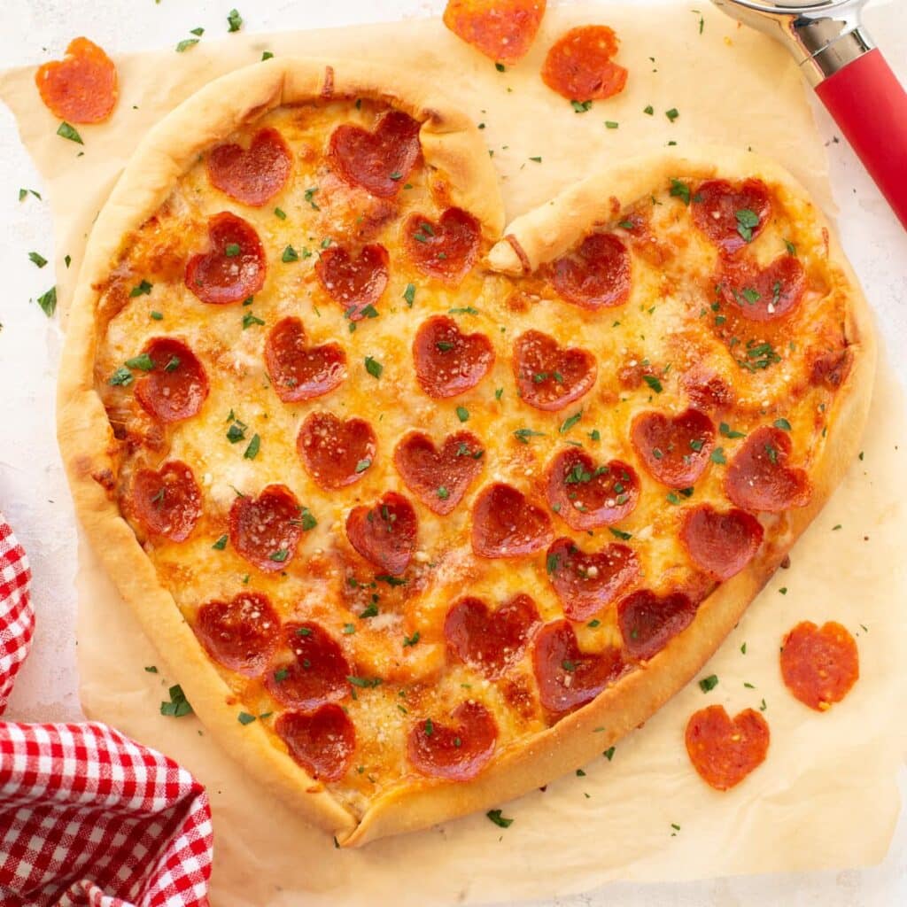 Heart-shaped pizza topped with melted cheese and pepperoni