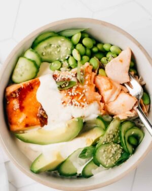 Honey Teriyaki Salmon Bowl with green vegetables and sauce.