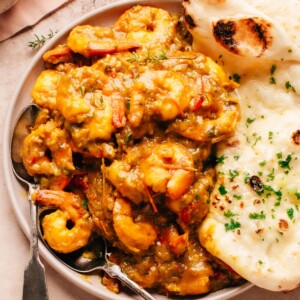 Jamaican Curry Shrimp on a plate with naan bread.