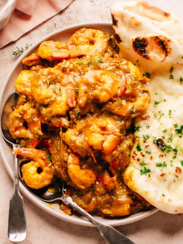 Jamaican Curry Shrimp on a plate with naan bread.