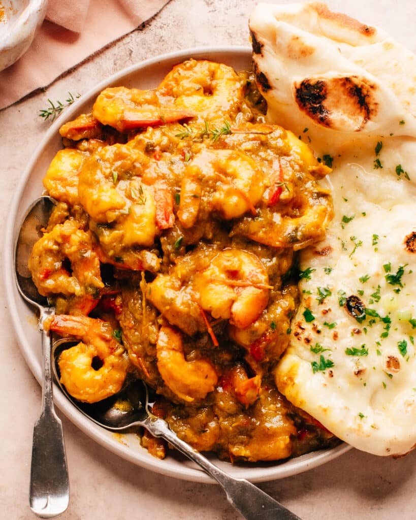Jamaican Curry Shrimp on a plate with naan bread
