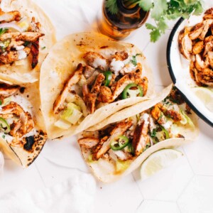 Chicken tacos on a table.