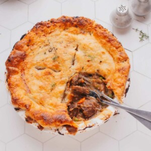 Beef Pot Pie with a piece removed and two forks,