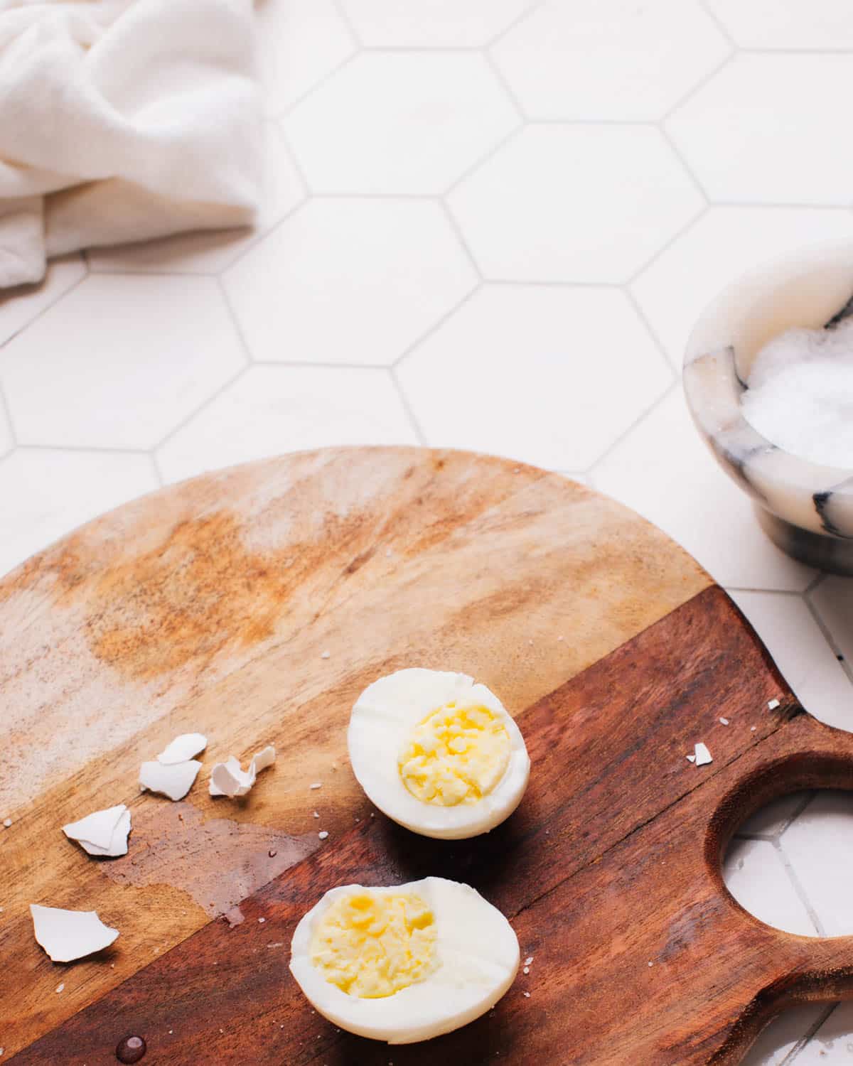 Hard boiled egg on a cutting board.