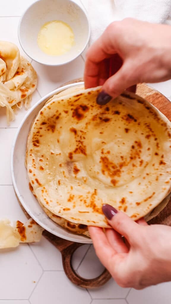 Placing paratha on a plate.